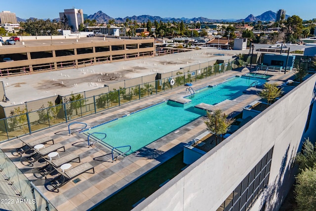 view of swimming pool with a patio area and a mountain view