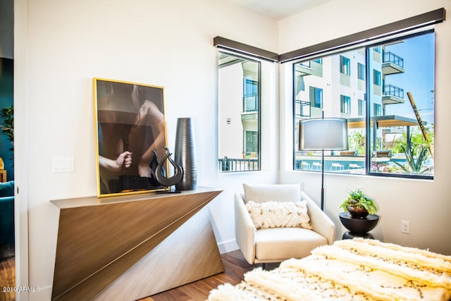 bedroom with hardwood / wood-style flooring and multiple windows