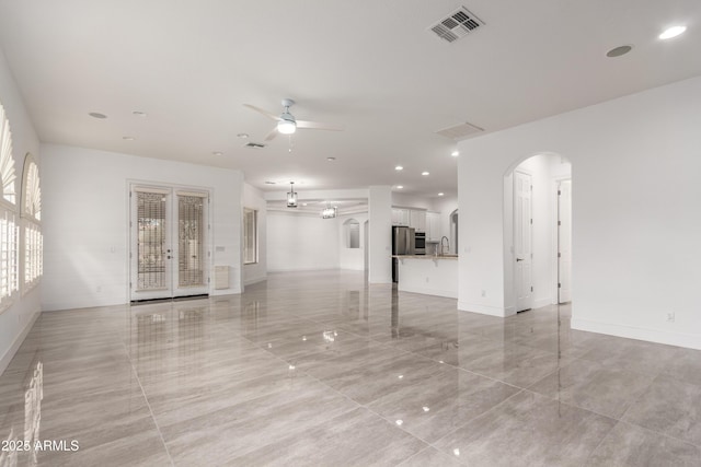 4711 E Buckboard Ct, Gilbert, AZ 85297 - unfurnished living room with arched walkways, a ceiling fan, recessed lighting, and baseboards