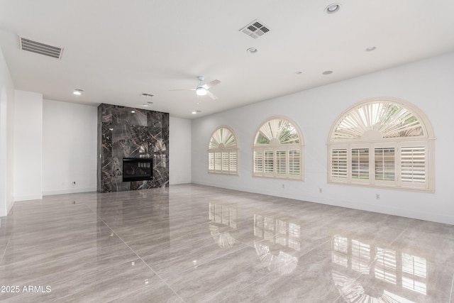 4711 E Buckboard Ct, Gilbert, AZ 85297 - unfurnished living room with ceiling fan, a high end fireplace, baseboards, recessed lighting, and light tile patterned floors