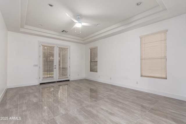4711 E Buckboard Ct, Gilbert, AZ 85297 - tiled spare room with a raised ceiling, ceiling fan, french doors, and baseboards