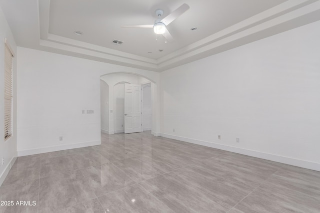 4711 E Buckboard Ct, Gilbert, AZ 85297 - spare room featuring a raised ceiling, ceiling fan, arched walkways, and baseboards