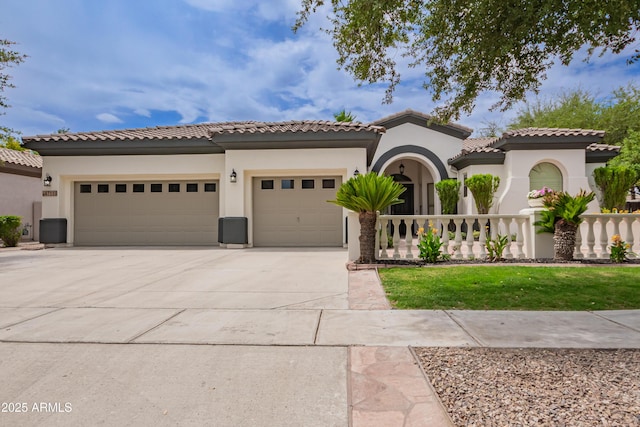 4711 E Buckboard Ct, Gilbert, AZ 85297 - mediterranean / spanish-style house featuring an attached garage, concrete driveway, stucco siding, a tile roof, and a front lawn