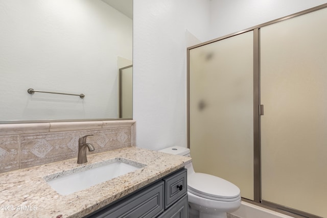 4711 E Buckboard Ct, Gilbert, AZ 85297 - bathroom with toilet, vanity, a stall shower, and decorative backsplash