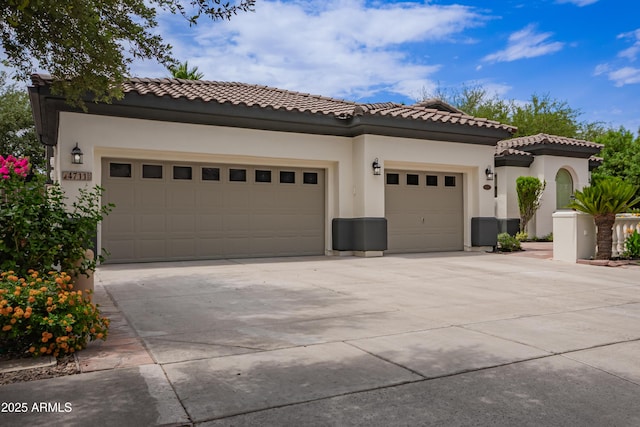 4711 E Buckboard Ct, Gilbert, AZ 85297 - mediterranean / spanish house featuring an attached garage, concrete driveway, stucco siding, and a tiled roof
