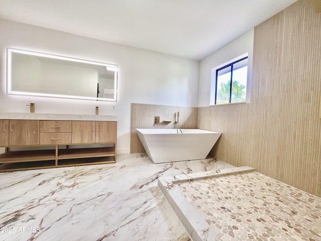 bathroom with a tub and vanity