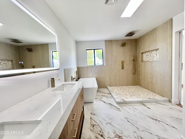 bathroom featuring vanity, wood walls, and plus walk in shower