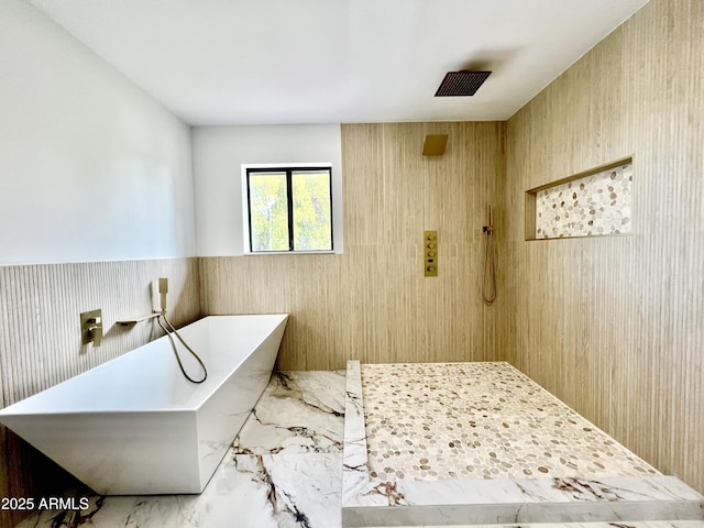 bathroom featuring separate shower and tub and wooden walls