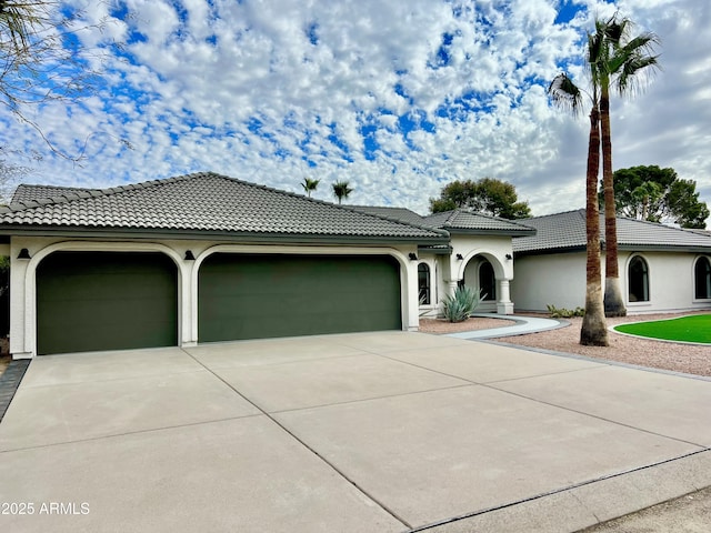 mediterranean / spanish home with a garage