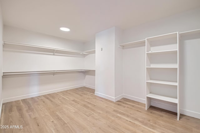 spacious closet featuring light hardwood / wood-style floors