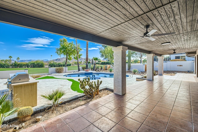 view of patio / terrace with a fenced in pool and ceiling fan