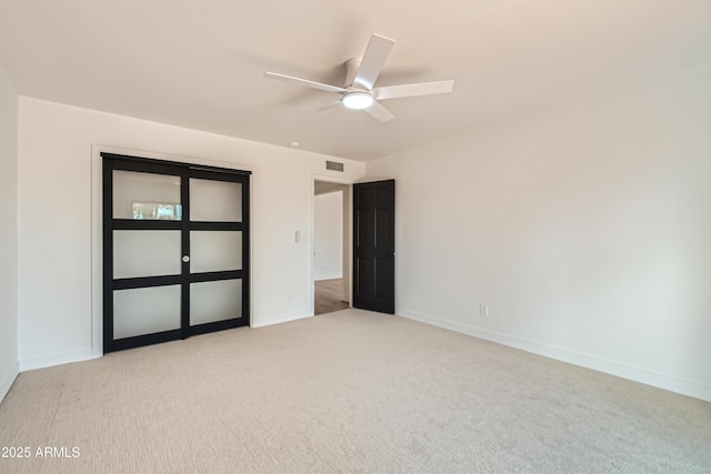 empty room with light carpet and ceiling fan