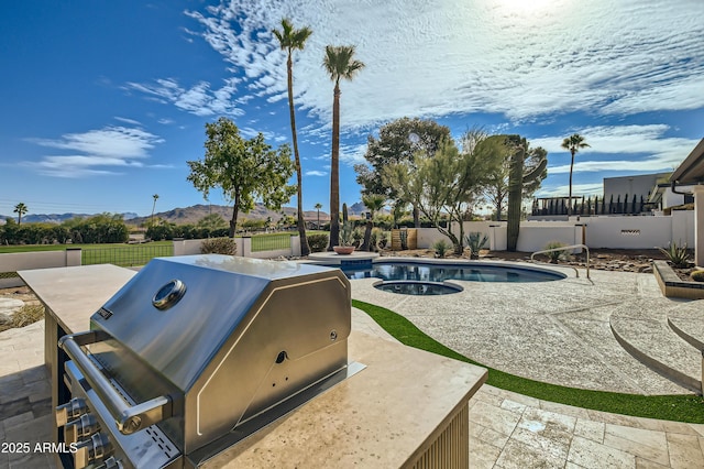 view of swimming pool with a grill and a patio area