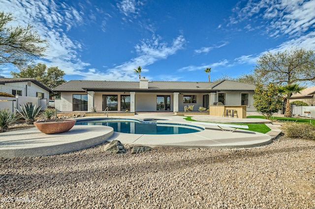 view of swimming pool featuring an in ground hot tub, an outdoor bar, and a patio