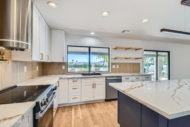 kitchen with appliances with stainless steel finishes, white cabinets, light stone counters, and sink