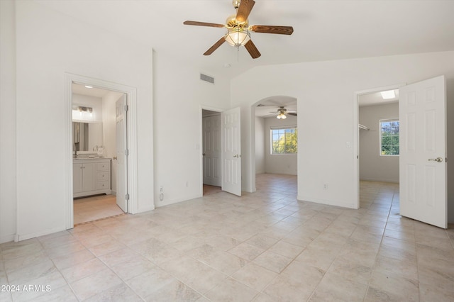 unfurnished room featuring lofted ceiling and ceiling fan