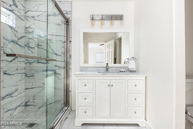 bathroom featuring vanity, toilet, and a shower with door