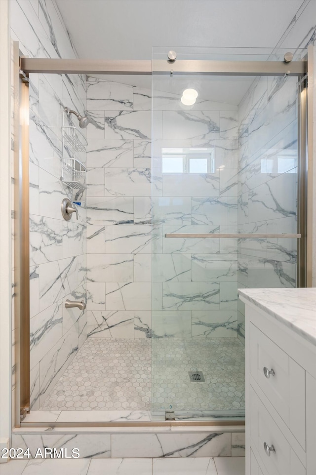 bathroom with vanity and walk in shower