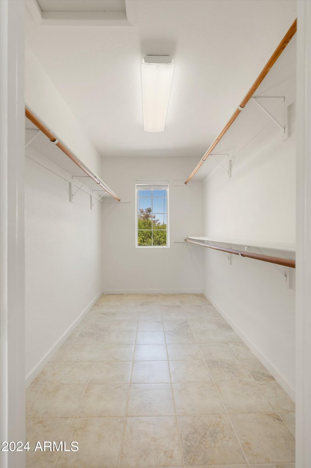 spacious closet with light tile patterned flooring