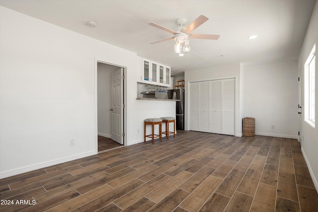 interior space featuring ceiling fan and dark hardwood / wood-style floors