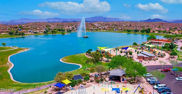 birds eye view of property with a water and mountain view