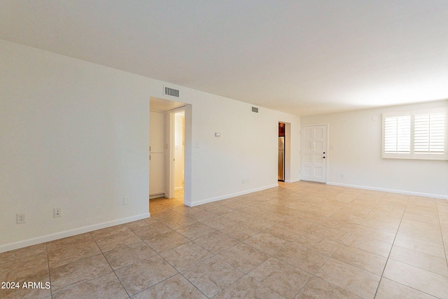 empty room with light tile patterned floors