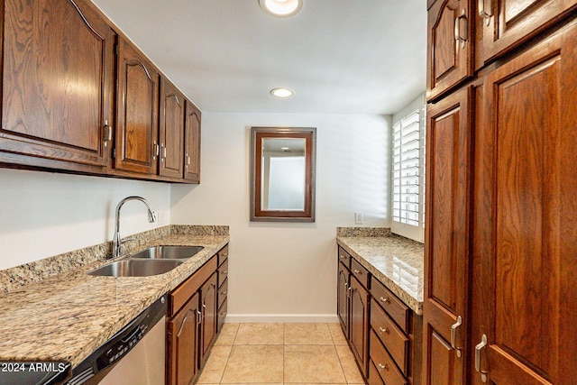 kitchen featuring light tile patterned floors, stainless steel dishwasher, sink, and light stone countertops