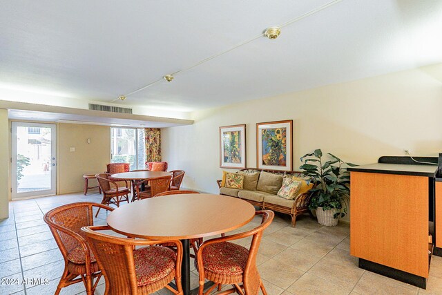 dining space featuring light tile patterned floors