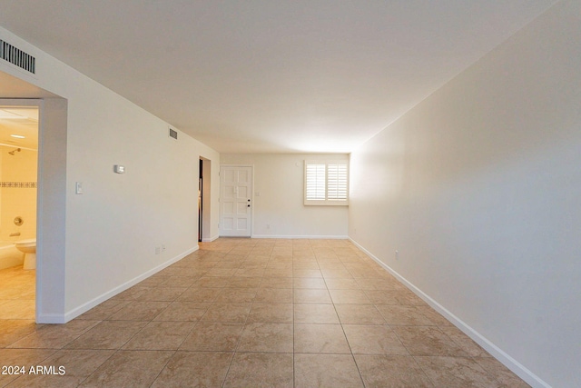 unfurnished room with light tile patterned floors