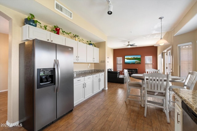 kitchen with wood finished floors, ceiling fan, stainless steel appliances, white cabinets, and visible vents