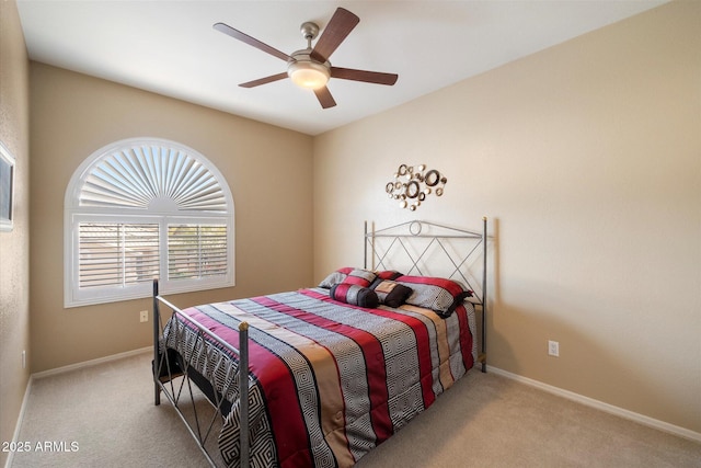 carpeted bedroom with baseboards and ceiling fan