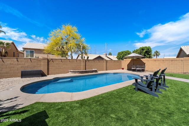 view of swimming pool featuring a lawn, a fenced backyard, a fenced in pool, and a patio area