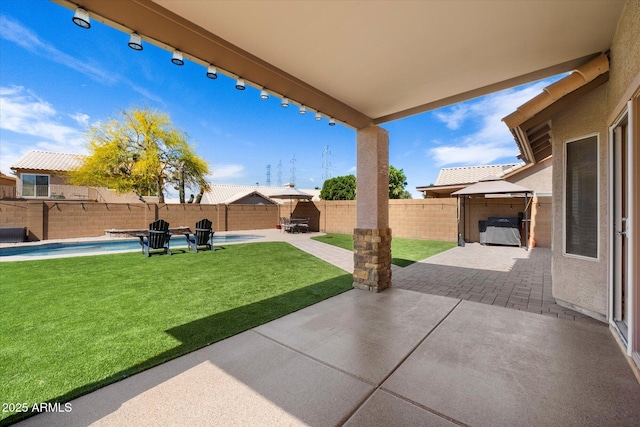 view of patio featuring a fenced backyard, a gazebo, and a fenced in pool