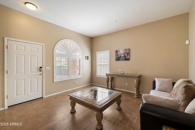 living area featuring baseboards and wood finished floors