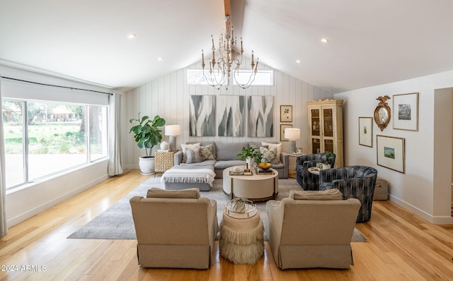 living room featuring a notable chandelier, lofted ceiling, and light wood-type flooring