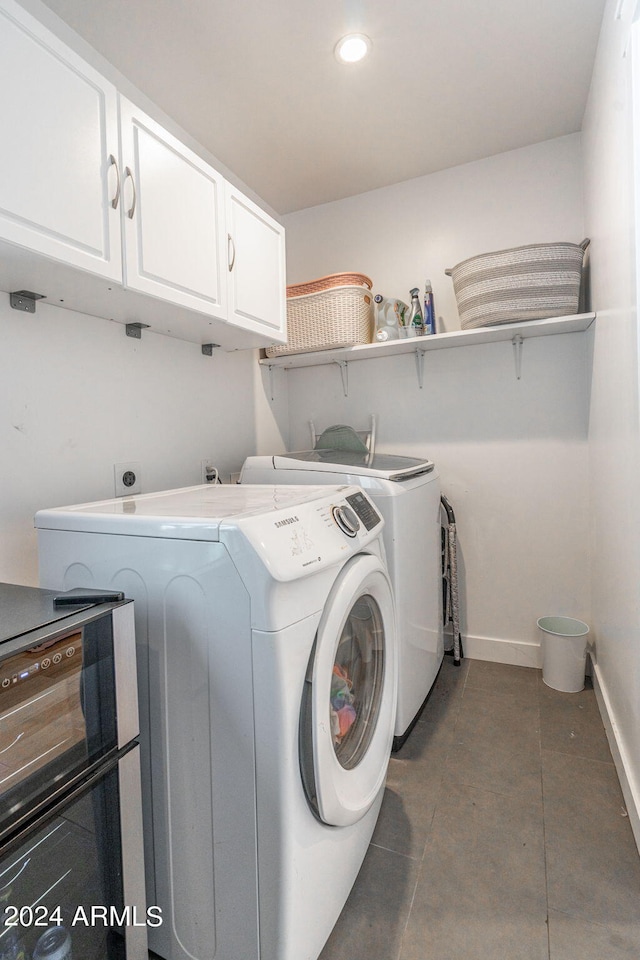 laundry area with cabinets and washing machine and dryer