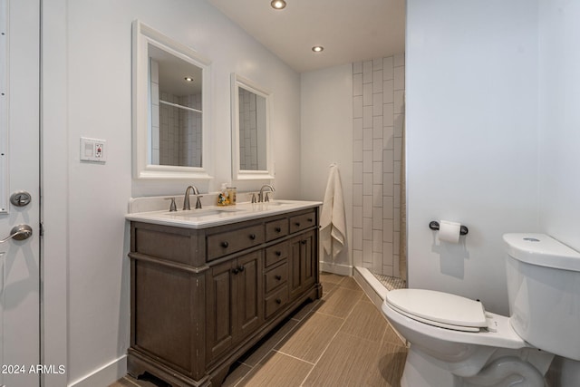 bathroom with vanity, toilet, and a shower