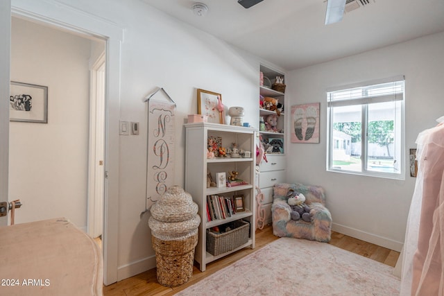 sitting room with ceiling fan and light wood-type flooring