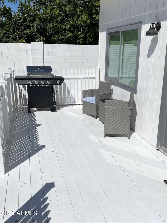 wooden deck featuring area for grilling