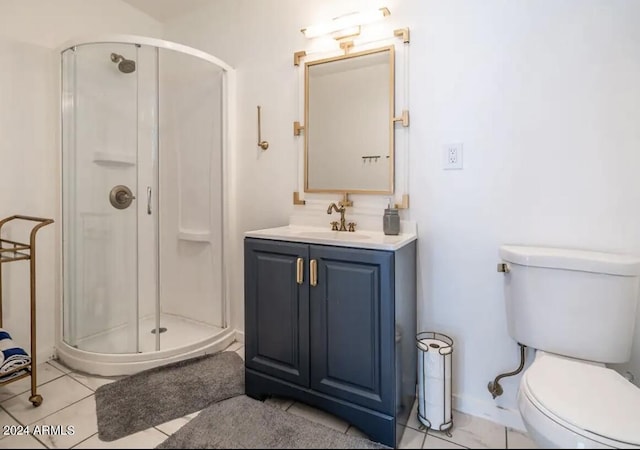 bathroom with tile patterned flooring, vanity, toilet, and walk in shower