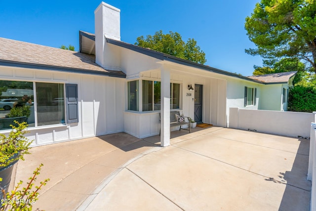 rear view of property featuring a patio area