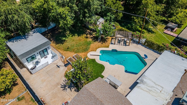 view of pool with a grill, an outdoor structure, and a patio