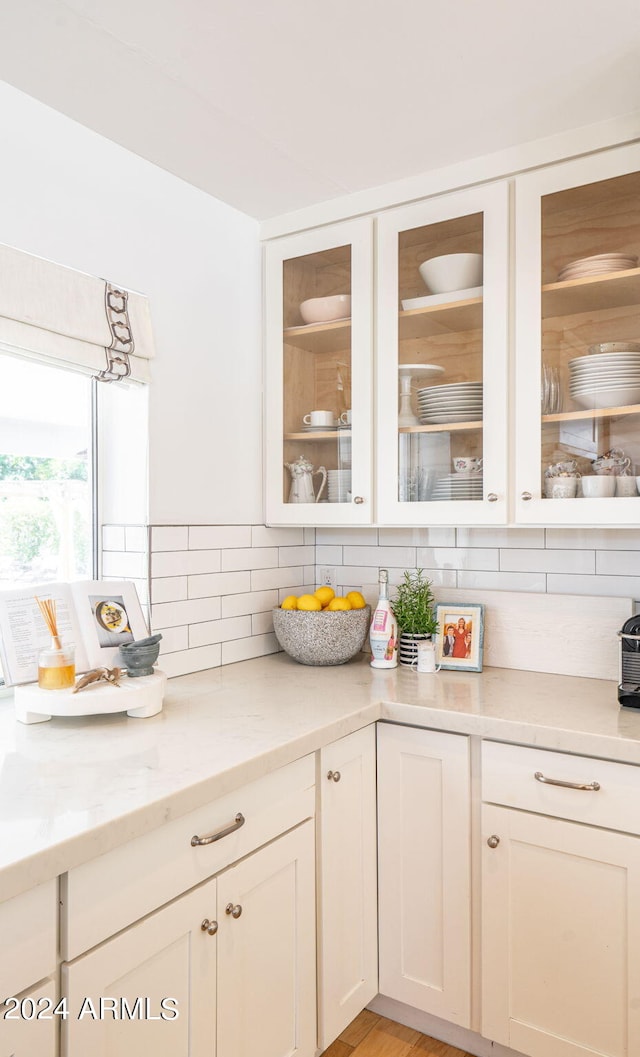 kitchen with light stone countertops and decorative backsplash