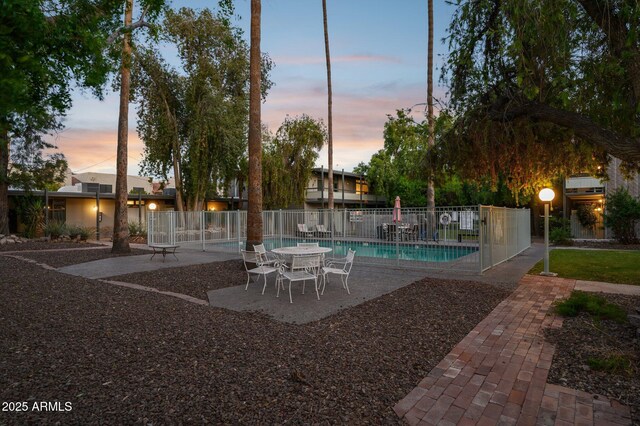 1101 E Bethany Home Rd Unit 1, Phoenix, AZ 85014 - pool at dusk featuring a patio area and a community pool