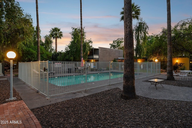 1101 E Bethany Home Rd Unit 1, Phoenix, AZ 85014 - pool at dusk with a community pool and a patio area