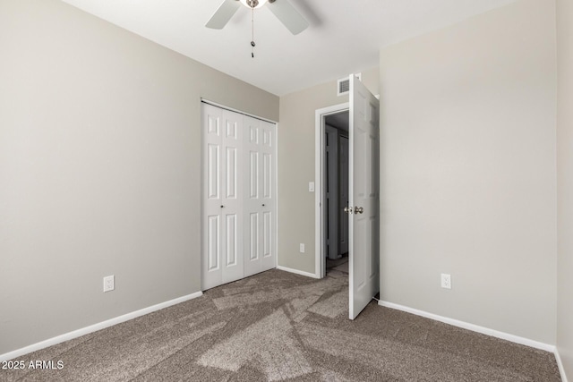 unfurnished bedroom with ceiling fan, visible vents, baseboards, a closet, and carpet