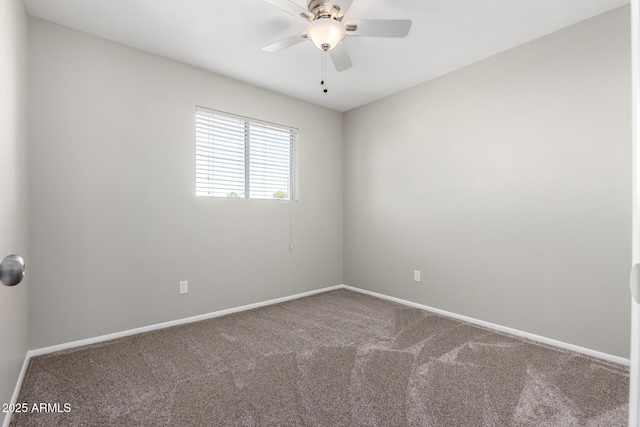 spare room featuring a ceiling fan, carpet flooring, and baseboards