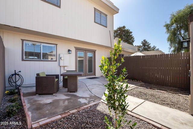 view of patio / terrace featuring french doors and fence