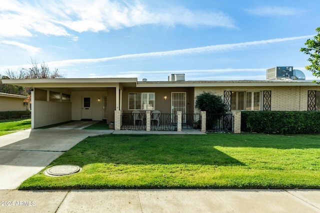 view of front of house featuring central AC, a front lawn, and a carport