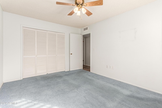 unfurnished bedroom with carpet, ceiling fan, and a closet